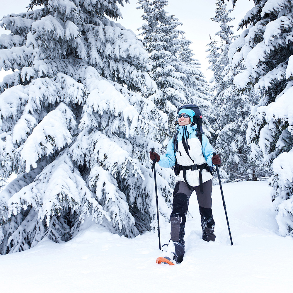 Person cross-country skiing on a trail in winter 