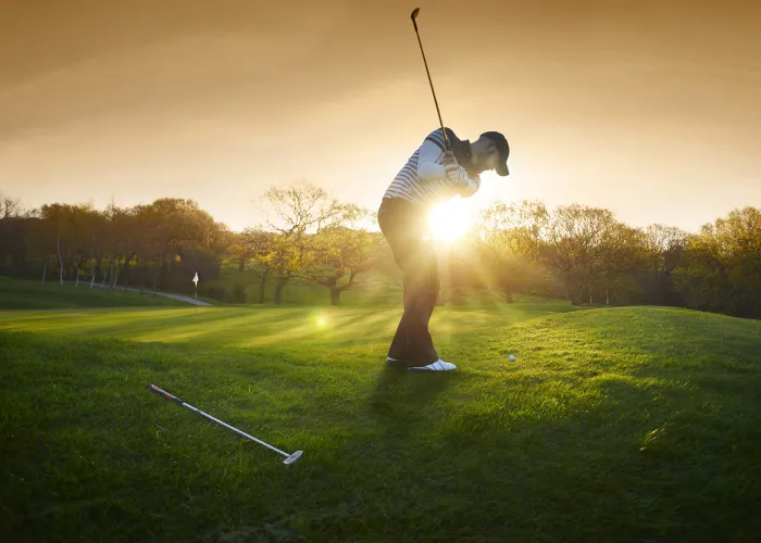 Golf swing at sunset 