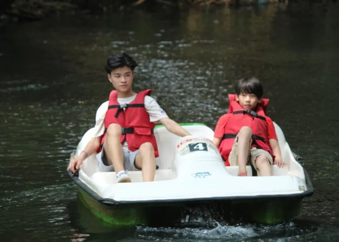 Two kids in a paddle boat