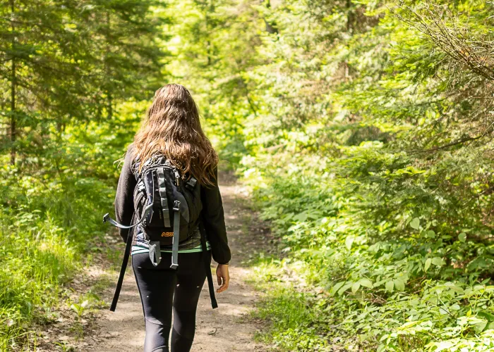 woman hiking on a trail at Egan Chutes Provincial Park in Bancroft, Ontario
