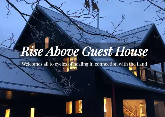 Photo of large house with many windows, snow on roof, dusk, name of venue in front of photo