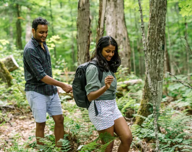 Couple hiking in a lush green forested trail in Madoc, Ontario 