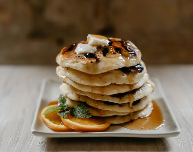pancakes on a plate with maple syrup